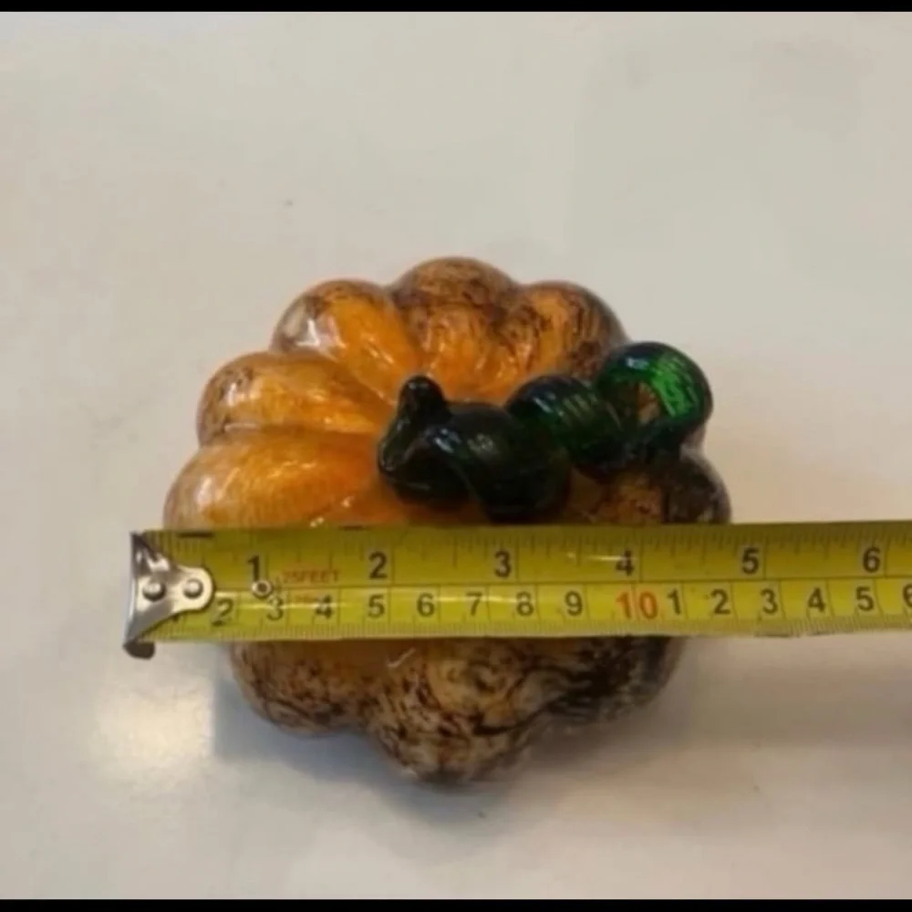 Orange and brown glass pumpkin with green stem